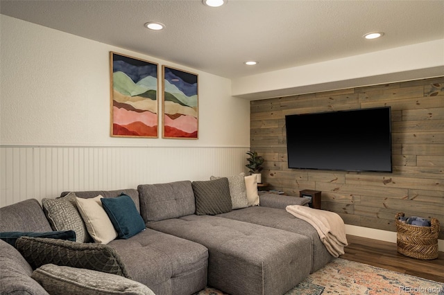 living room with hardwood / wood-style flooring and wooden walls