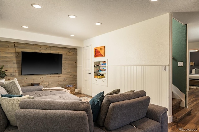 living room featuring hardwood / wood-style flooring and wooden walls