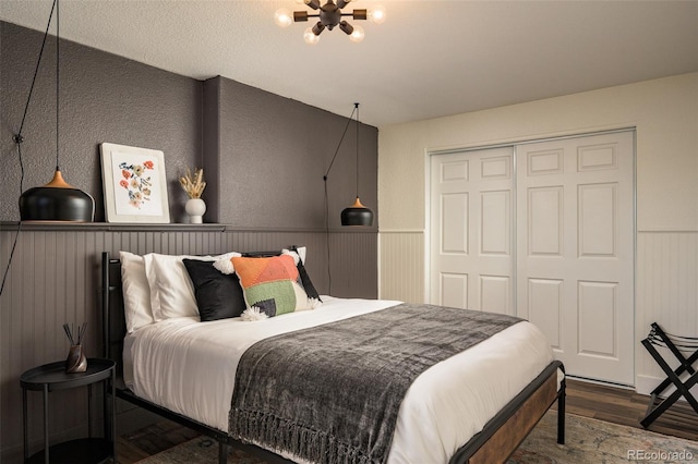 bedroom with hardwood / wood-style floors and a closet