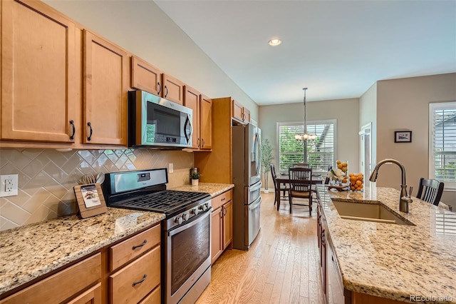 15852 Lavender Pl, Broomfield, CO 80023 - kitchen with stainless steel appliances, light wood finished floors, plenty of natural light, tasteful backsplash, and recessed lighting