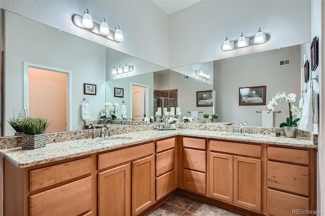 15852 Lavender Pl, Broomfield, CO 80023 - full bathroom with double vanity, a shower stall, and tile patterned flooring