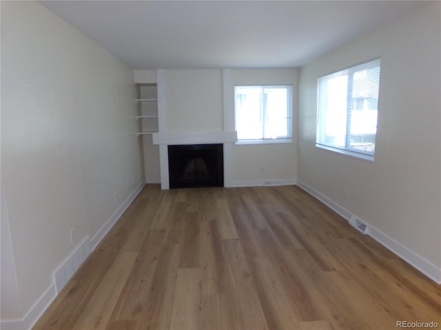 unfurnished living room with light hardwood / wood-style flooring