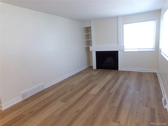 unfurnished living room with light wood-type flooring