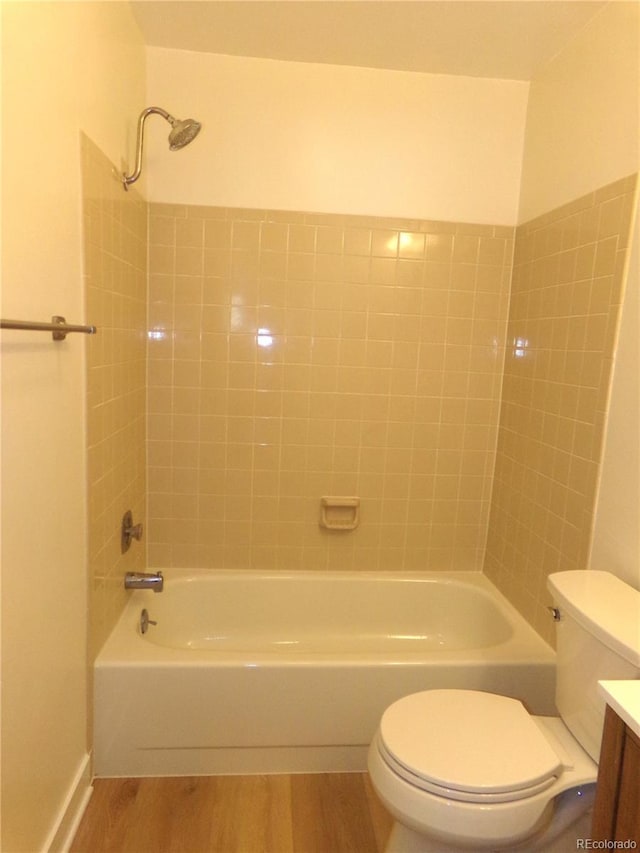 full bathroom featuring tiled shower / bath, toilet, vanity, and wood-type flooring