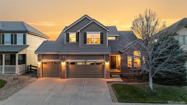 11991 Hazy Hills Dr, Parker, CO 80138 - view of front of house with brick siding, driveway, and an attached garage