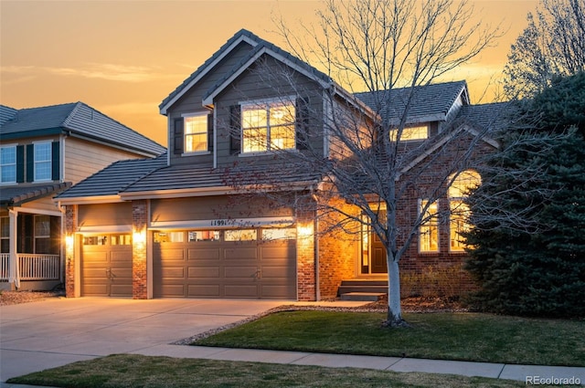 11991 Hazy Hills Dr, Parker, CO 80138 - traditional-style house featuring concrete driveway, brick siding, a garage, and a tile roof