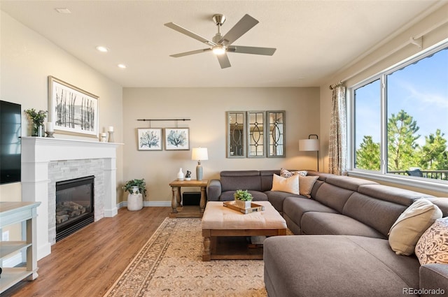 11991 Hazy Hills Dr, Parker, CO 80138 - living area featuring baseboards, light wood-type flooring, recessed lighting, a fireplace, and a ceiling fan