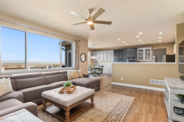11991 Hazy Hills Dr, Parker, CO 80138 - living area featuring light wood-style floors, a ceiling fan, visible vents, recessed lighting, and baseboards