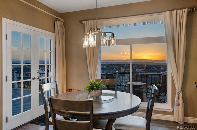 11991 Hazy Hills Dr, Parker, CO 80138 - dining space with french doors, baseboards, an inviting chandelier, and wood finished floors