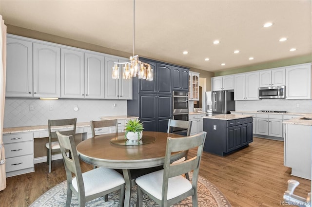 11991 Hazy Hills Dr, Parker, CO 80138 - dining space with recessed lighting, a notable chandelier, and wood finished floors