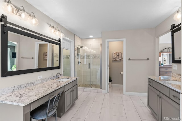 11991 Hazy Hills Dr, Parker, CO 80138 - bathroom featuring a sink, baseboards, two vanities, and a stall shower