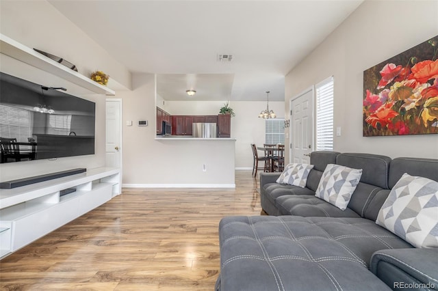living room with light wood finished floors and baseboards