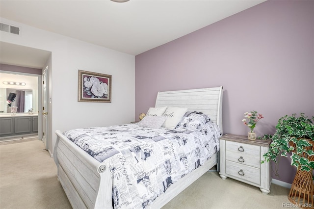 bedroom featuring light carpet and connected bathroom
