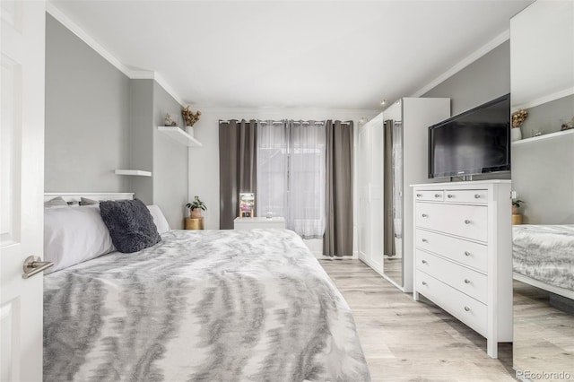 bedroom featuring light wood-style flooring and crown molding