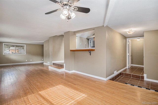 28532 Shadow Mountain Dr, Conifer, CO 80433 - unfurnished living room featuring a ceiling fan, baseboards, and wood finished floors