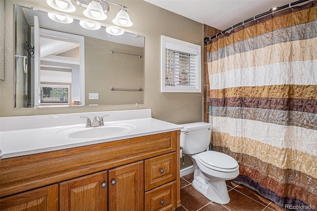 bathroom with toilet, vanity, a shower with shower curtain, and tile patterned flooring