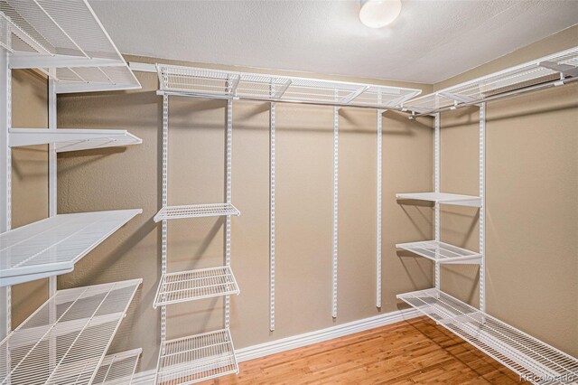 28532 Shadow Mountain Dr, Conifer, CO 80433 - walk in closet with wood finished floors