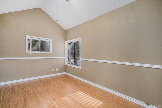 28532 Shadow Mountain Dr, Conifer, CO 80433 - unfurnished room with vaulted ceiling, wood finished floors, and baseboards