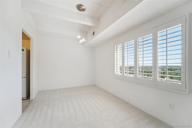 unfurnished room with visible vents and carpet