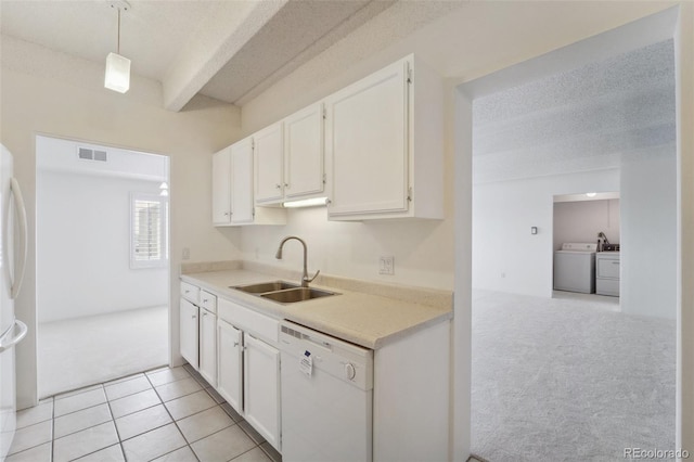 kitchen with light colored carpet, a sink, dishwasher, white cabinetry, and visible vents