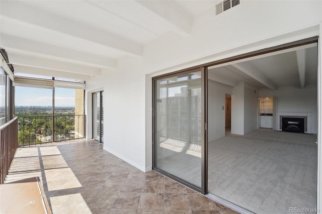 interior space featuring beamed ceiling and visible vents