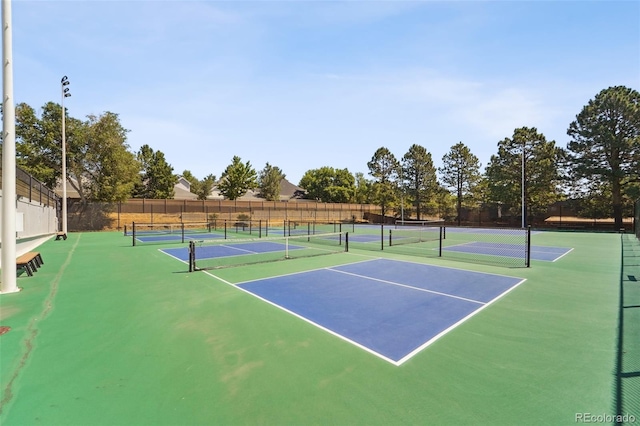 view of tennis court featuring fence