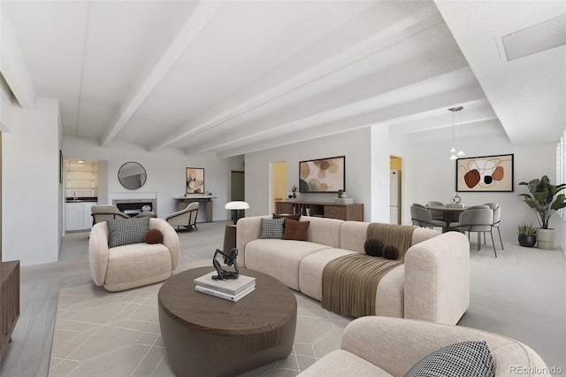 7865 E Mississippi Ave Unit 1502, Denver, CO 80247 - living room with beamed ceiling, light colored carpet, a fireplace, and a chandelier