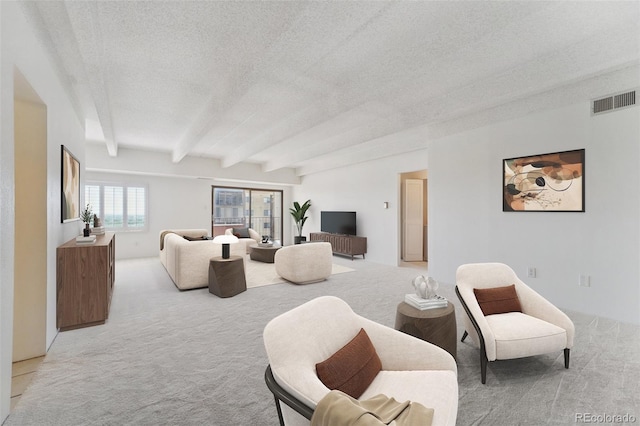 7865 E Mississippi Ave Unit 1502, Denver, CO 80247 - living room with light carpet, beam ceiling, and a textured ceiling