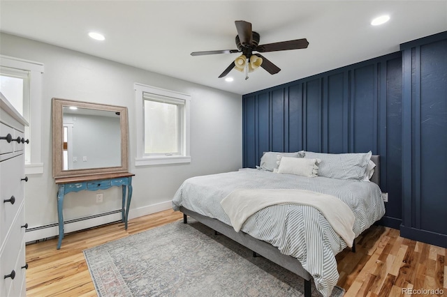 31551 Black Widow Dr, Conifer, CO 80433 - bedroom featuring baseboard heating, wood finished floors, recessed lighting, and a ceiling fan