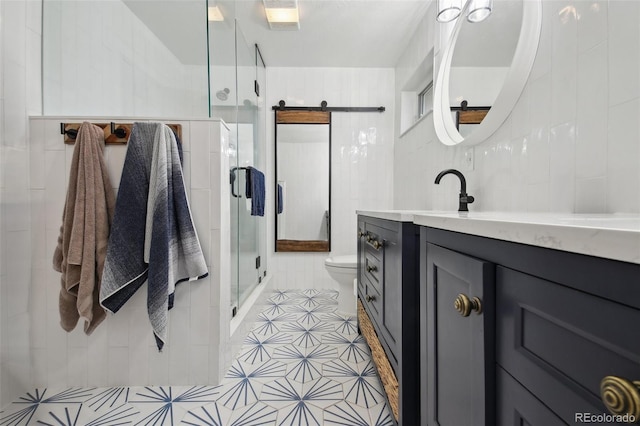 31551 Black Widow Dr, Conifer, CO 80433 - full bath featuring vanity, a shower stall, tile walls, and tile patterned floors
