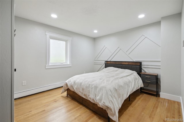 31551 Black Widow Dr, Conifer, CO 80433 - bedroom featuring baseboard heating, light wood-style flooring, and recessed lighting