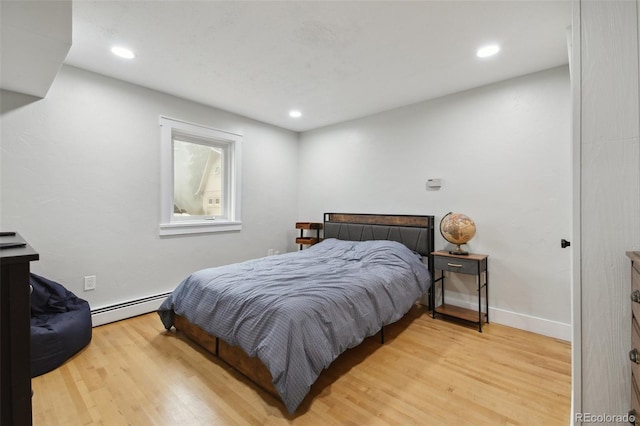 31551 Black Widow Dr, Conifer, CO 80433 - bedroom with a baseboard radiator, light wood-type flooring, and recessed lighting