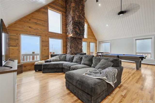 31551 Black Widow Dr, Conifer, CO 80433 - living room with high vaulted ceiling, billiards table, wood walls, and light wood-style floors