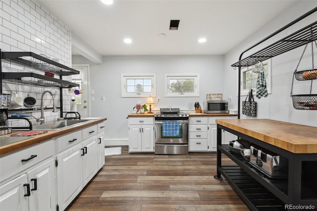 31551 Black Widow Dr, Conifer, CO 80433 - kitchen featuring wooden counters, appliances with stainless steel finishes, open shelves, dark wood-style floors, and recessed lighting