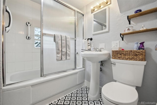 31551 Black Widow Dr, Conifer, CO 80433 - full bath featuring bath / shower combo with glass door and a textured wall
