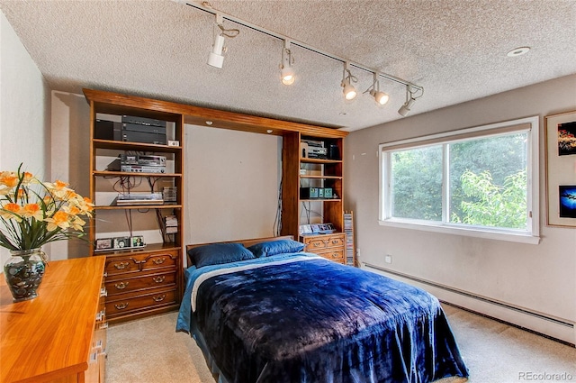 8888 W 37th Pl, Wheat Ridge, CO 80033 - bedroom featuring a baseboard heating unit, carpet flooring, a textured ceiling, and rail lighting