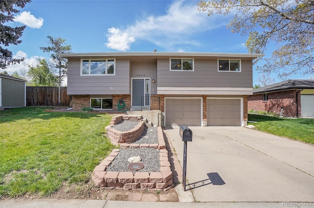 9099 W Harvard Pl, Lakewood, CO 80227 - bi-level home featuring brick siding, an attached garage, and driveway