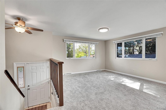 9099 W Harvard Pl, Lakewood, CO 80227 - carpeted empty room featuring baseboards and a ceiling fan