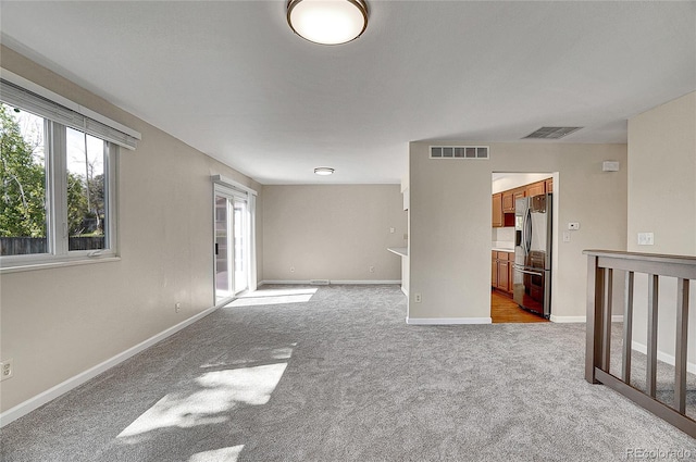 9099 W Harvard Pl, Lakewood, CO 80227 - spare room featuring light carpet and baseboards