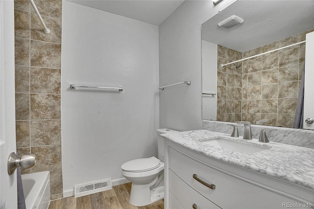 9099 W Harvard Pl, Lakewood, CO 80227 - bathroom featuring wood finished floors, toilet, vanity, and baseboards