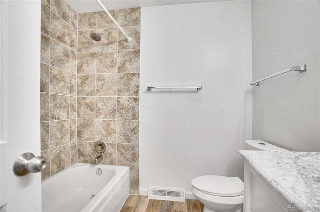 9099 W Harvard Pl, Lakewood, CO 80227 - full bath featuring wood finished floors, vanity, toilet, and shower / tub combination