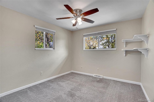 9099 W Harvard Pl, Lakewood, CO 80227 - carpeted spare room featuring healthy amount of natural light, baseboards, and a ceiling fan