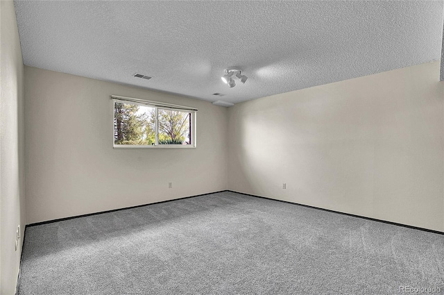 9099 W Harvard Pl, Lakewood, CO 80227 - spare room with carpet, a textured ceiling, and baseboards
