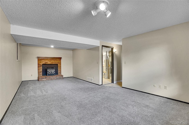 9099 W Harvard Pl, Lakewood, CO 80227 - unfurnished living room with a brick fireplace, carpet floors, a textured ceiling, gas water heater, and baseboards