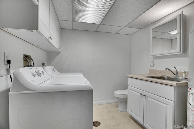 9099 W Harvard Pl, Lakewood, CO 80227 - bathroom with washer and dryer, toilet, vanity, a drop ceiling, and tile patterned floors