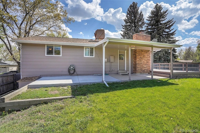 9099 W Harvard Pl, Lakewood, CO 80227 - back of property featuring a chimney, a patio, and a wooden deck