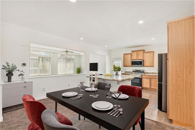 dining space featuring ceiling fan and light tile patterned flooring