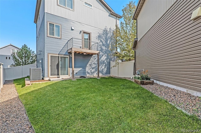 rear view of property featuring a lawn and cooling unit