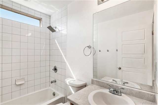 full bathroom with vanity, tiled shower / bath combo, and toilet