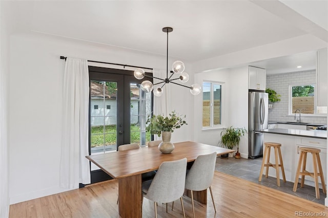 3440 N Harrison St, Denver, CO 80205 - dining area with a chandelier, french doors, and light wood finished floors